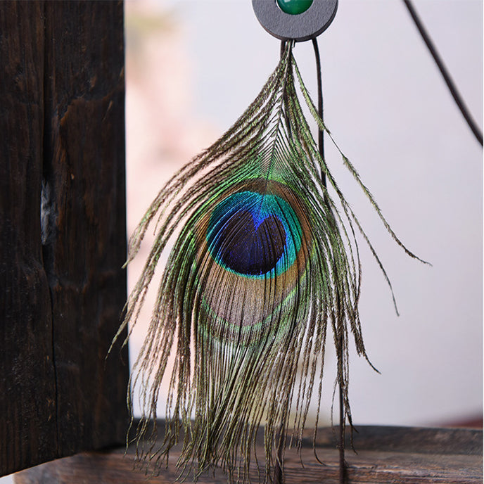 Plume de paon à la mode et collier pendentif en verre