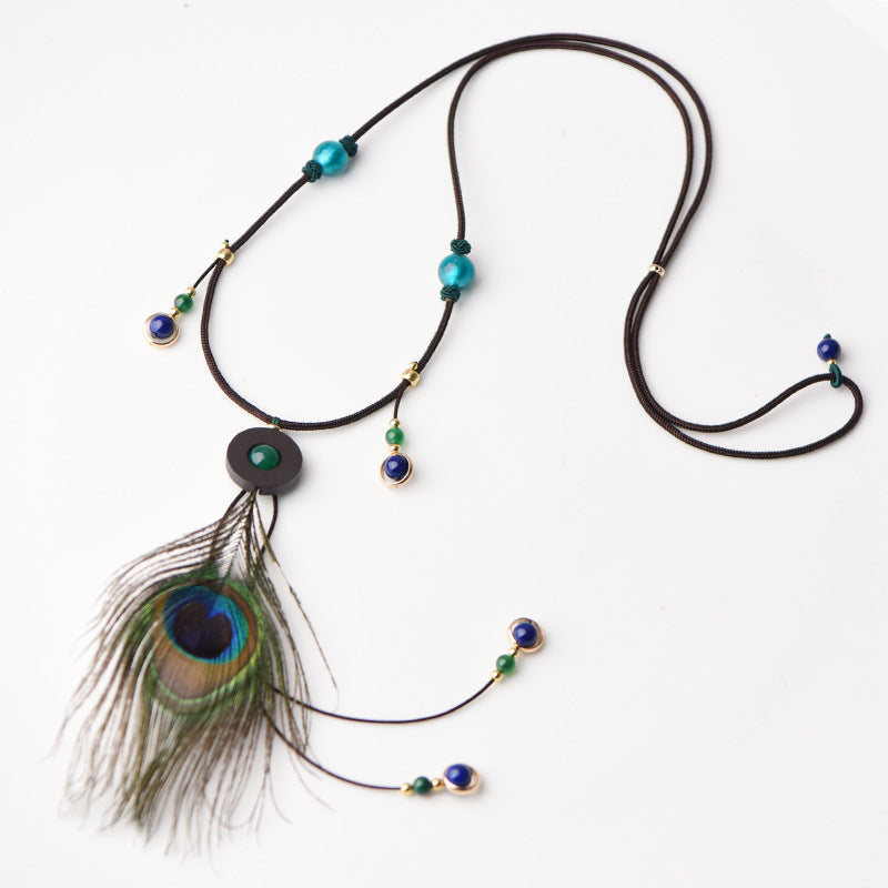 Plume de paon à la mode et collier pendentif en verre